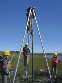 VIMS Professor Chris Hein (atop vibracore tripod) joins with W&M undergrads to take a sediment core. From L: Sarah Baker (W&M ’17),  Jennifer Connell (W&M ’17, VIMS lab tech), Jessica Raff (W&M ’17). © D. Ciarletta, Montclair State University.