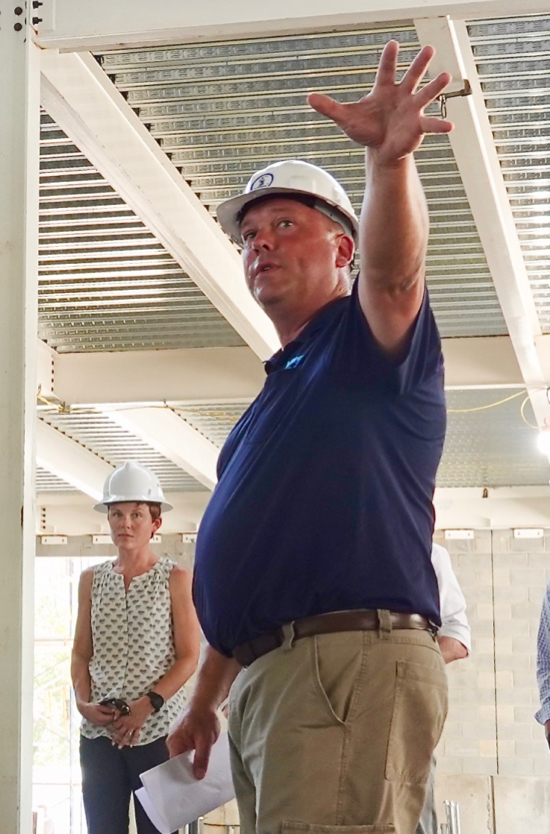 Dr. Jess Moss Small (background), ABC associate director, joins Acuff project manager Dana Snyder for a tour of the Acuff Center as part of a June 30 "topping-off" ceremony attended by individuals from VIMS, Kjellstrom + Lee Construction, and Quinn Evans architects. © D. Malmquist/VIMS.